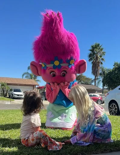Pink Troll party character in Houston